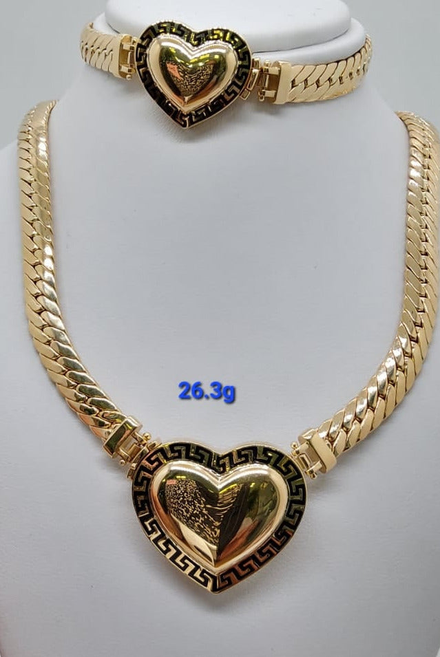 A gold-colored necklace with a heart-shaped pendant displayed on a mannequin bust, with the necklace's weight indicated as 25 grams.